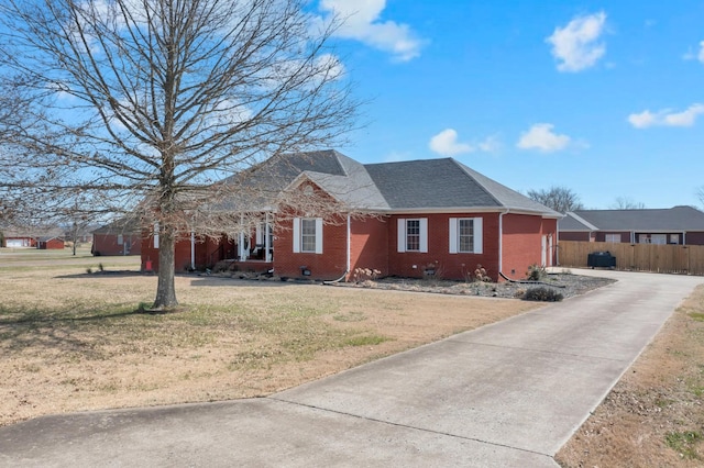 single story home with brick siding, crawl space, a front yard, and fence