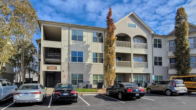 view of building exterior with uncovered parking