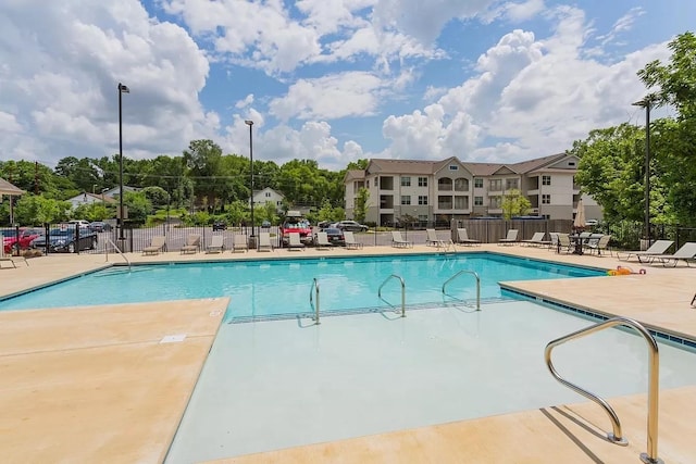 pool with fence and a patio