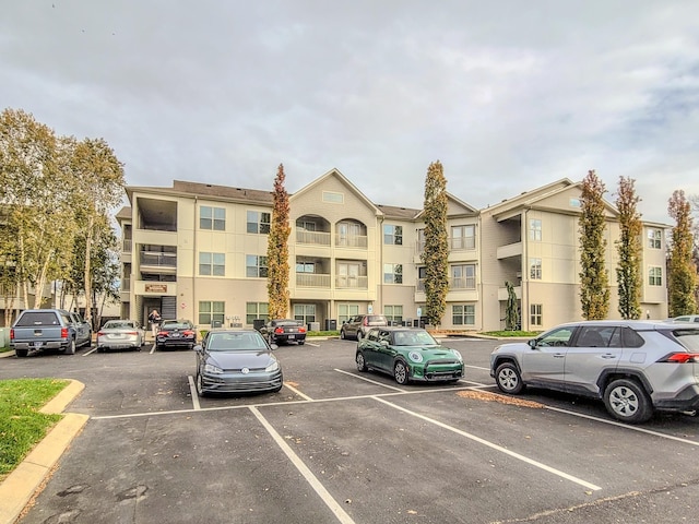 view of property featuring uncovered parking