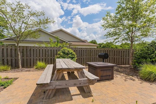 view of patio / terrace featuring outdoor dining area, fence, and a grill