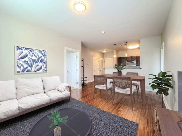 living area featuring dark wood finished floors and baseboards