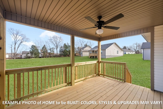 deck with ceiling fan, a yard, and a residential view