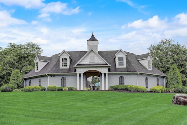 view of front of home featuring brick siding, a front lawn, and roof with shingles