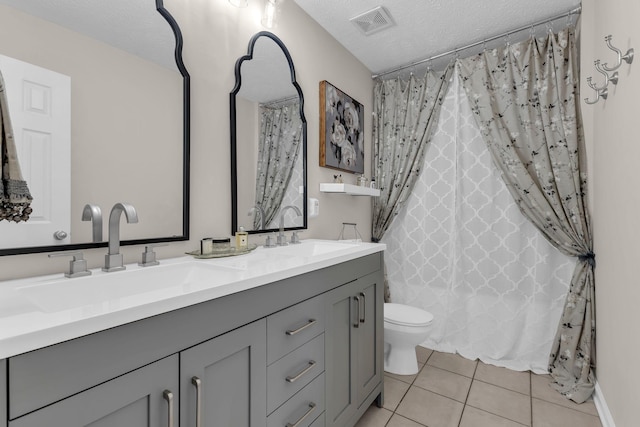 full bath featuring tile patterned flooring, visible vents, a sink, and a textured ceiling