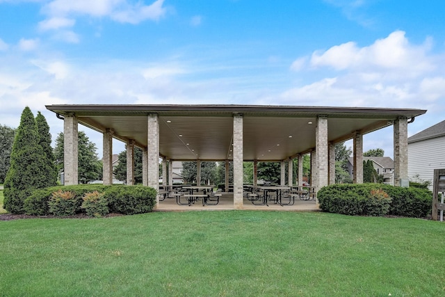 view of home's community with a patio area and a lawn