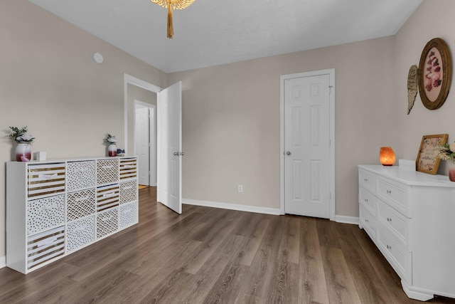 bedroom featuring baseboards and wood finished floors