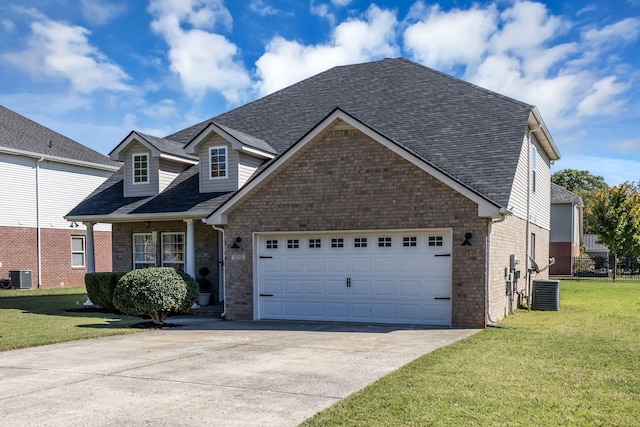 view of front of home with central AC unit, concrete driveway, an attached garage, a front yard, and brick siding