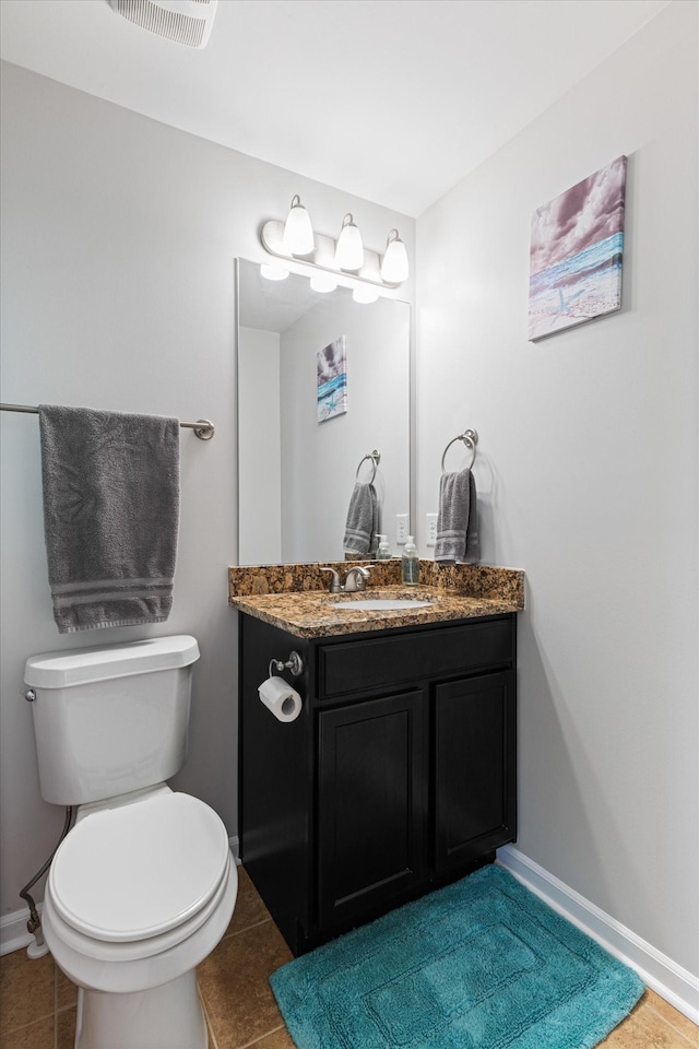 bathroom with baseboards, visible vents, toilet, tile patterned floors, and vanity