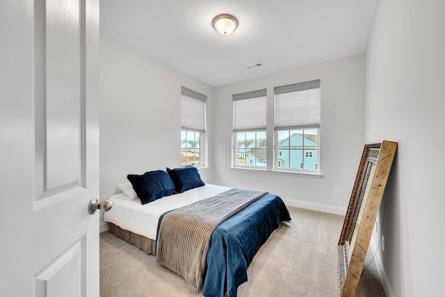 bedroom with light carpet, baseboards, and visible vents