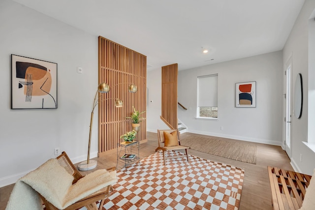 living area featuring stairs, baseboards, wood finished floors, and recessed lighting