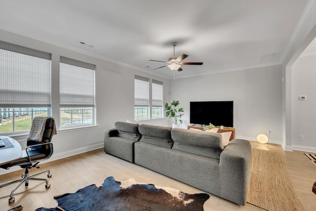 living room with baseboards, light wood finished floors, visible vents, and crown molding