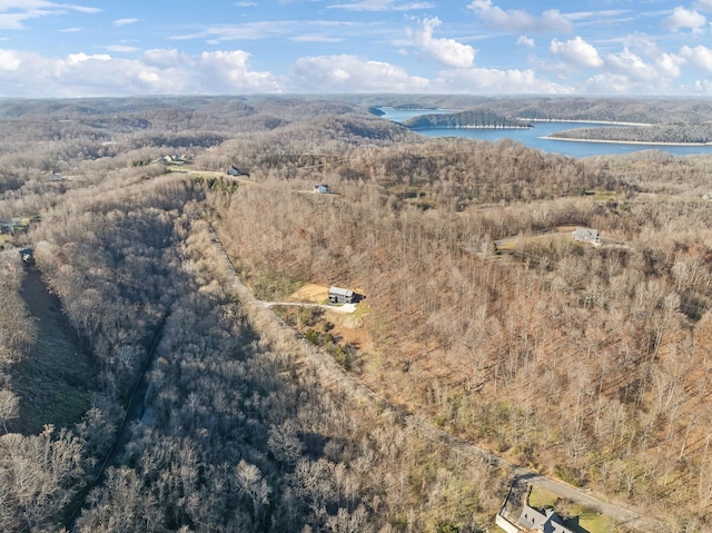 birds eye view of property with a water view and a wooded view