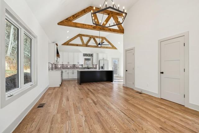 kitchen with light countertops, light wood-style floors, visible vents, and stainless steel fridge with ice dispenser