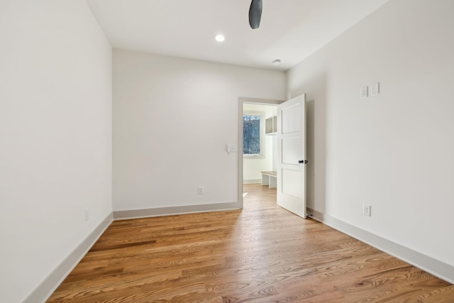 empty room featuring light wood-style floors, recessed lighting, and baseboards