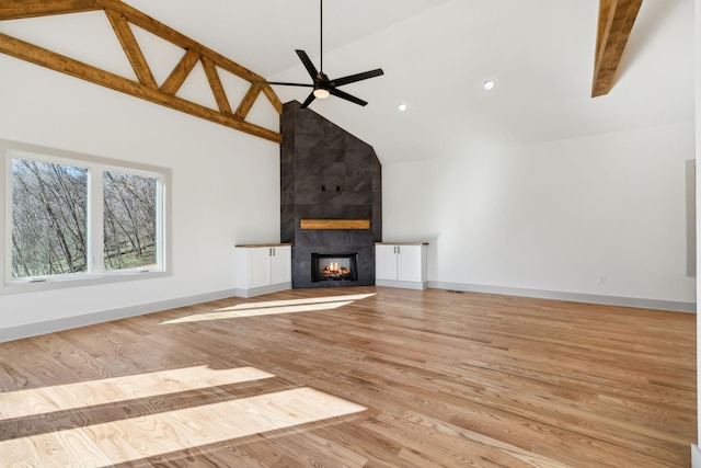 unfurnished living room featuring baseboards, wood finished floors, and a multi sided fireplace