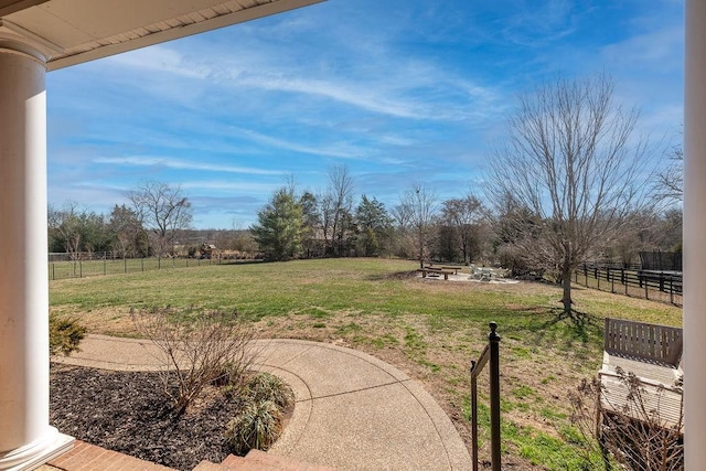 view of yard featuring a patio area, fence, and a rural view