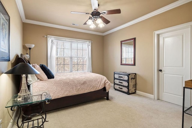 carpeted bedroom featuring baseboards, visible vents, ceiling fan, and crown molding