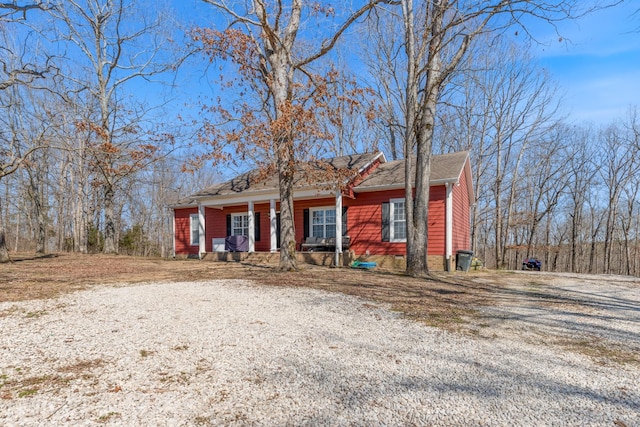 view of front of property with gravel driveway and a porch