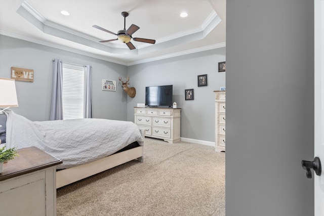 bedroom with light carpet, baseboards, ornamental molding, a tray ceiling, and recessed lighting