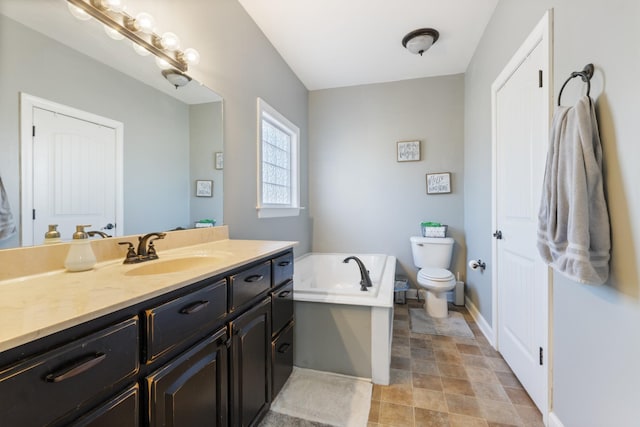 full bath featuring toilet, baseboards, a bath, and vanity