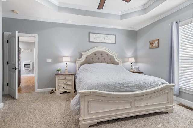 bedroom featuring carpet floors, visible vents, ornamental molding, heating unit, and a raised ceiling