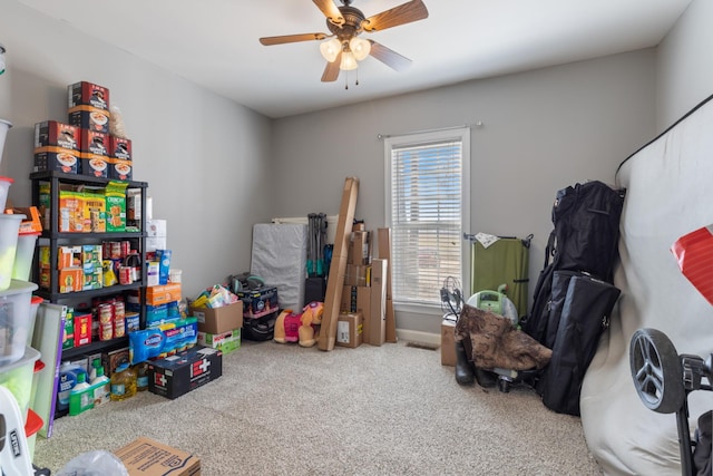 recreation room featuring a ceiling fan and carpet flooring