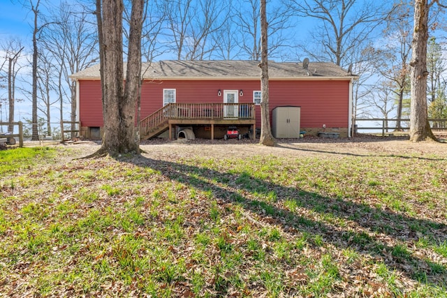 rear view of house with stairway, fence, a deck, and an outdoor structure