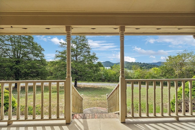 exterior space featuring a mountain view and a lawn