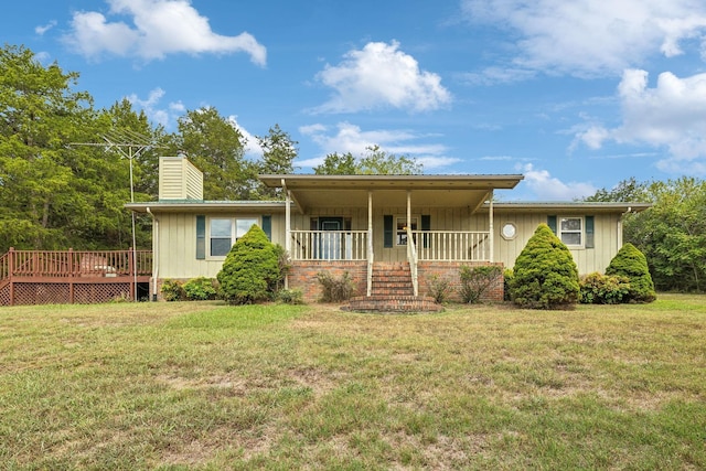 ranch-style house with covered porch, a chimney, and a front lawn