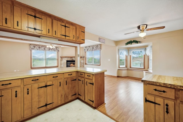 kitchen with light countertops, a wealth of natural light, and brown cabinets