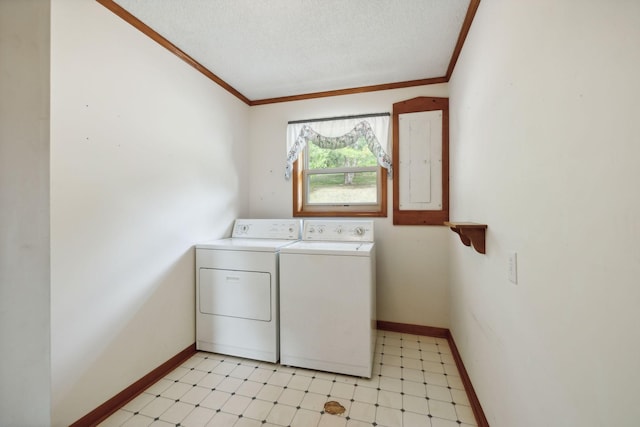 washroom with crown molding, light floors, washing machine and dryer, a textured ceiling, and laundry area