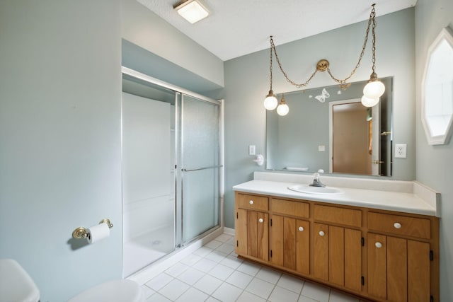 bathroom featuring tile patterned floors, a shower stall, toilet, and vanity