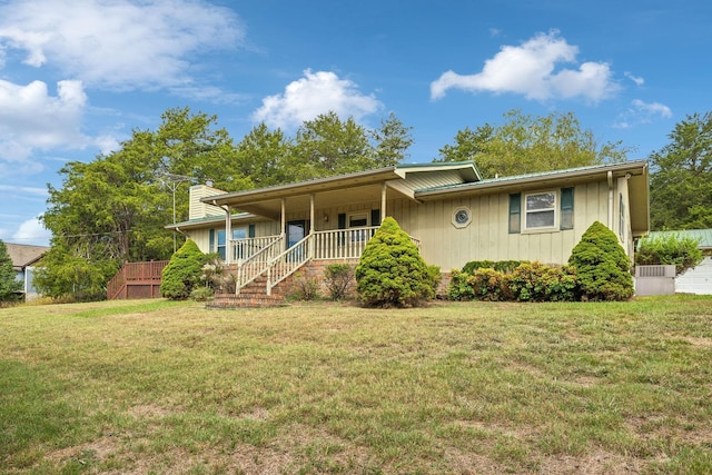 ranch-style house with a front lawn, a chimney, a porch, and stairway