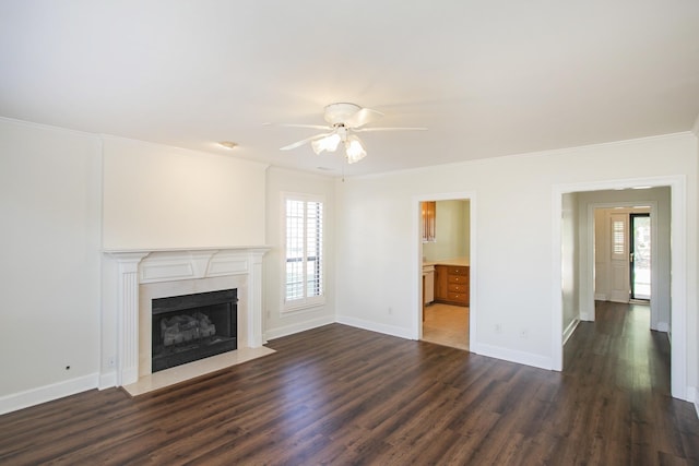 unfurnished living room with dark wood-type flooring, crown molding, and plenty of natural light