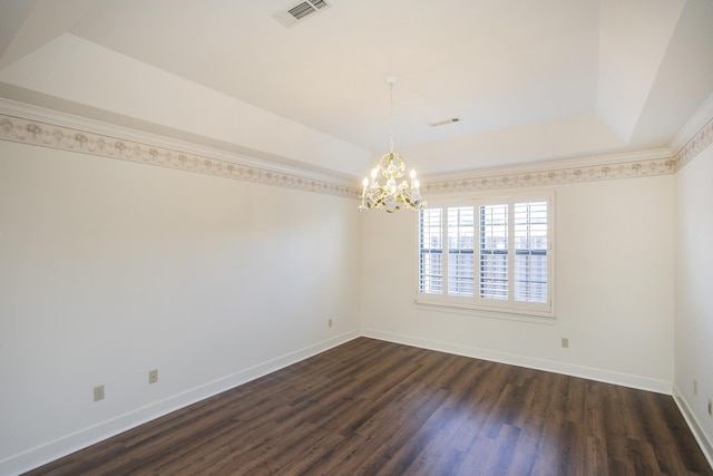 spare room featuring baseboards, visible vents, a raised ceiling, dark wood-style floors, and a notable chandelier