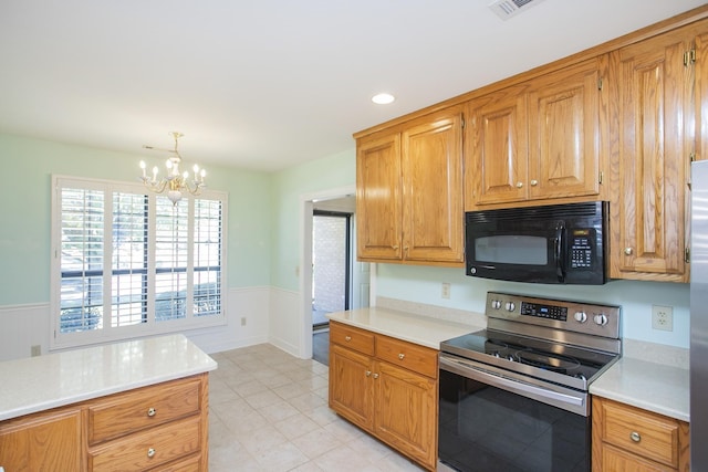 kitchen featuring a chandelier, electric stove, brown cabinets, light countertops, and black microwave