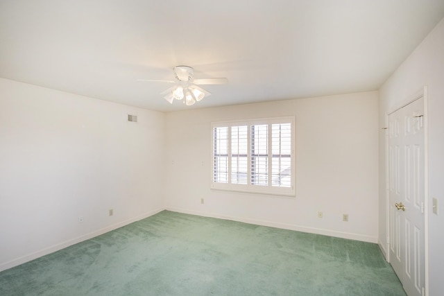 unfurnished room featuring baseboards, ceiling fan, visible vents, and light colored carpet