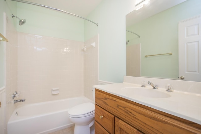 bathroom featuring  shower combination, vanity, toilet, and tile patterned floors