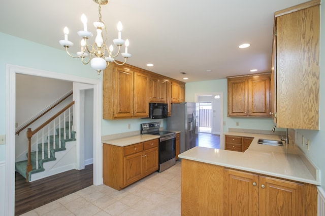 kitchen featuring appliances with stainless steel finishes, brown cabinets, light countertops, a sink, and recessed lighting