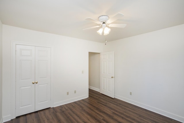 unfurnished bedroom with a ceiling fan, a closet, dark wood finished floors, and baseboards