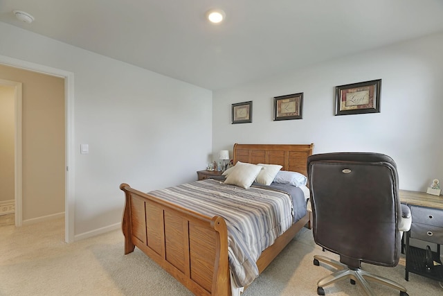 bedroom with light carpet and baseboards