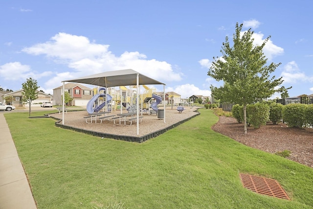 community jungle gym with a residential view and a yard