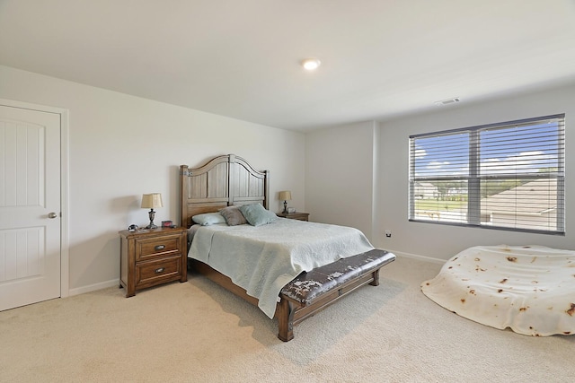 bedroom with carpet floors, visible vents, and baseboards