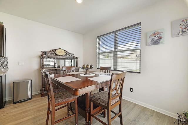 dining room with light wood-type flooring and baseboards