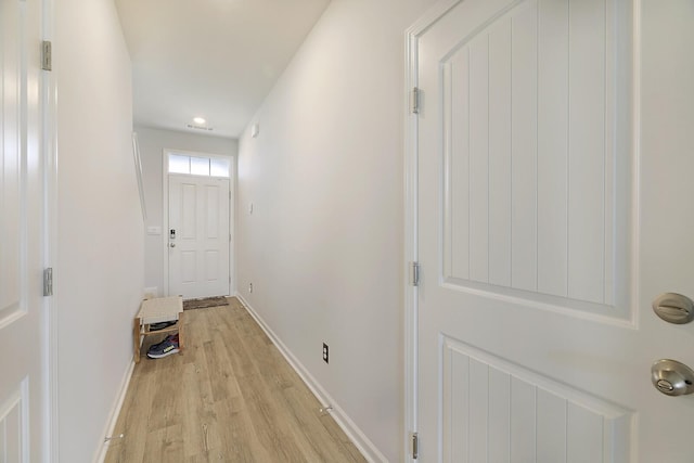 entryway with baseboards and light wood finished floors