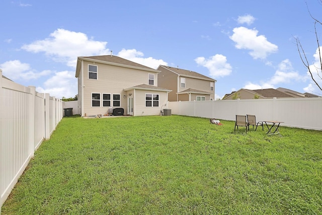 back of property featuring a lawn, a fenced backyard, and central air condition unit