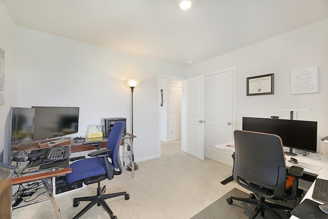 office space with light carpet and baseboards