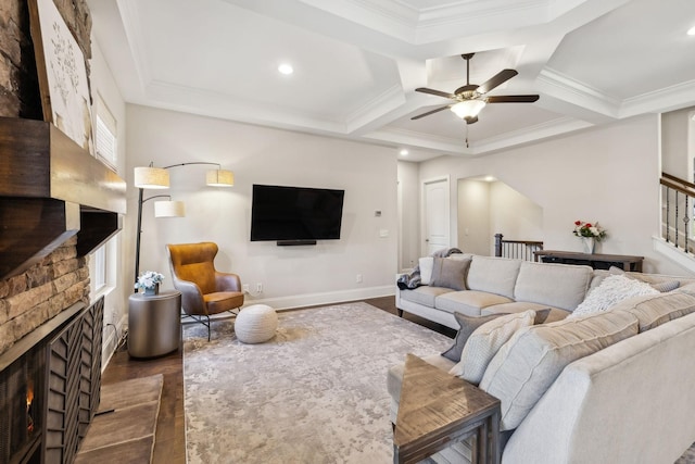 living room with baseboards, ornamental molding, dark wood-type flooring, stairs, and a brick fireplace