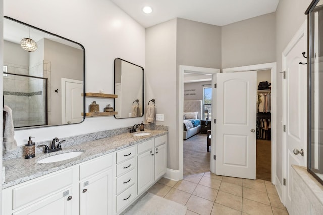 full bathroom with a stall shower, tile patterned flooring, a sink, and double vanity